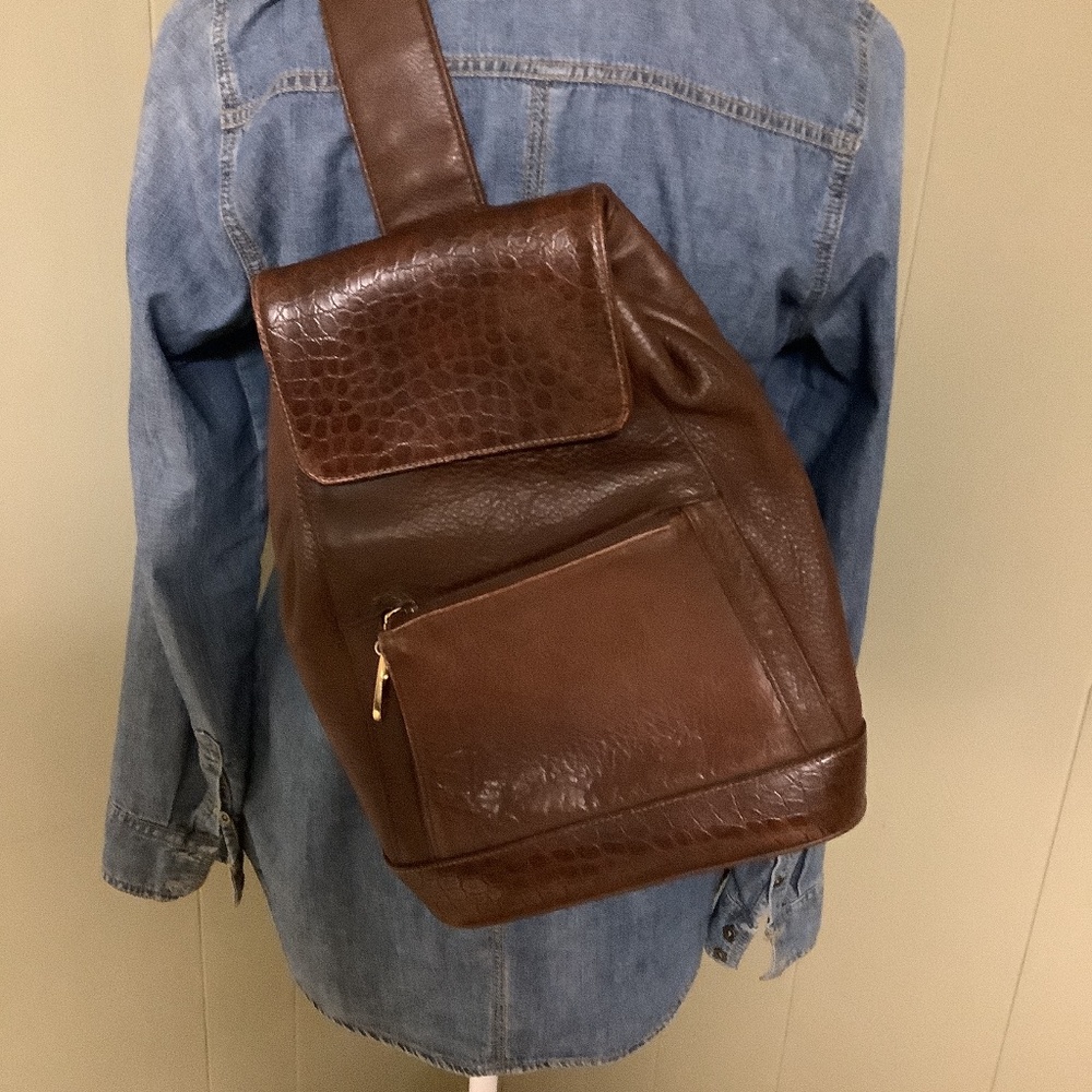 Brown leather sling bag.